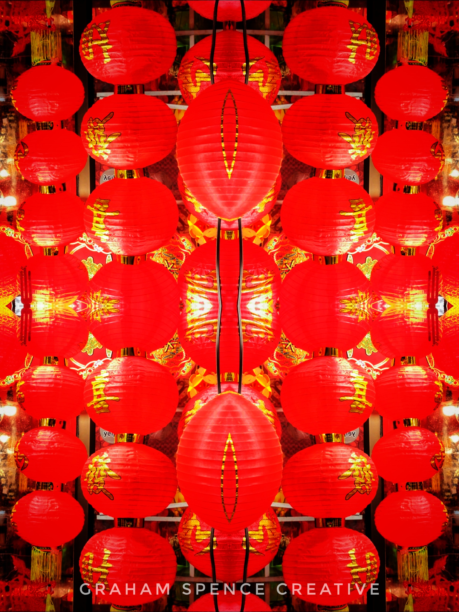 A mirrored photo of red lanterns in a China Town window display in Vancouver.